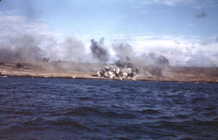 Explosions on an Iwo Jima beach, with smoke from other blasts drifting down wind, probably during the pre-landing bombardment, 19 Feb 1945