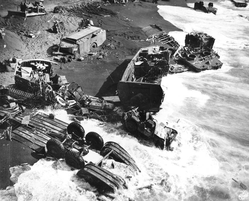 Destroyed equipment on the beach of Iwo Jima, Japan, 1945. Note the overturned DUKW and two wrecked LCVPs.