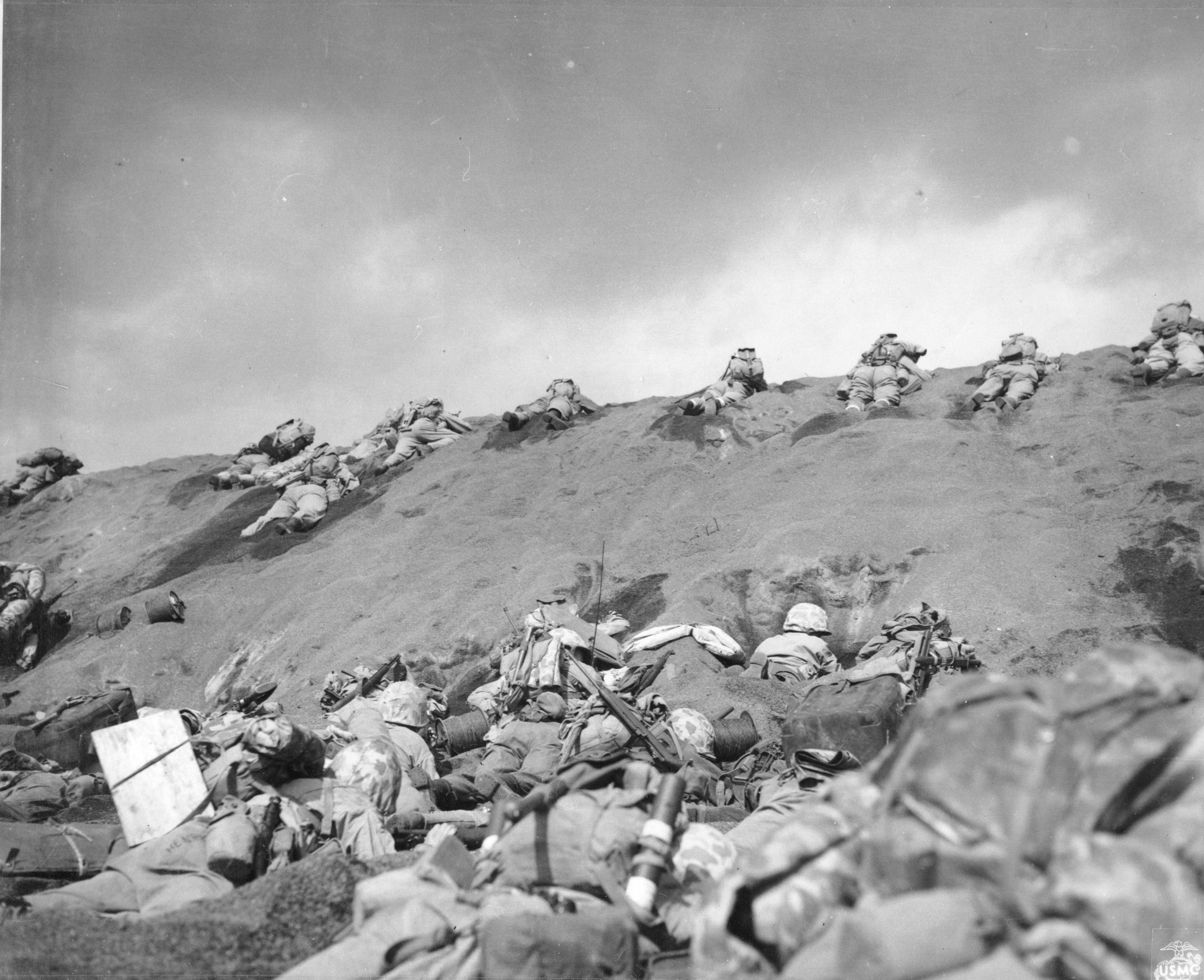 Men of USMC 5th Division advancing through the volcanic ash hills of Red Beach No. 1 at Iwo Jima, Japan, 19 Feb 1945, photo 1 of 2