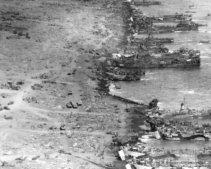 Landing ships and craft unloading on Iwo Jima's eastern beaches, 25 Feb 1945; photo taken from atop Mount Suribachi