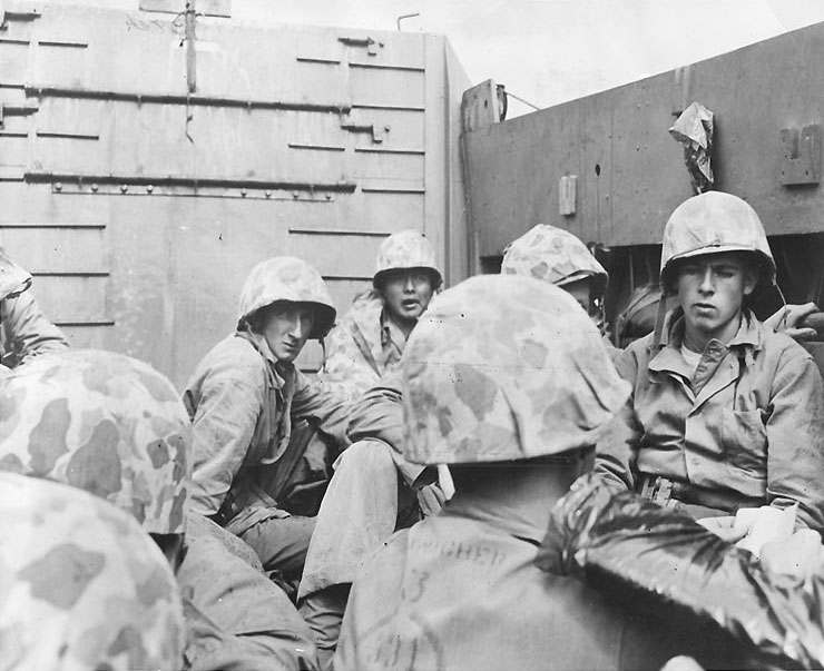 Marines crouched in a Coast Guard-manned LCVP on the way in on the first wave to hit the beach at Iwo Jima, 19 Feb 1945, photo 1 of 2