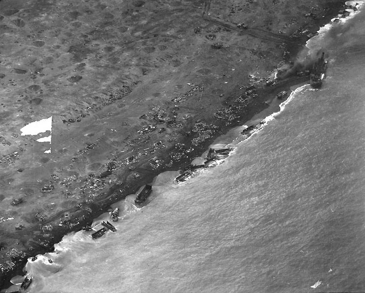 Aerial photo of wrecked American landing craft at Iwo Jima Beach, 21 Feb 1945