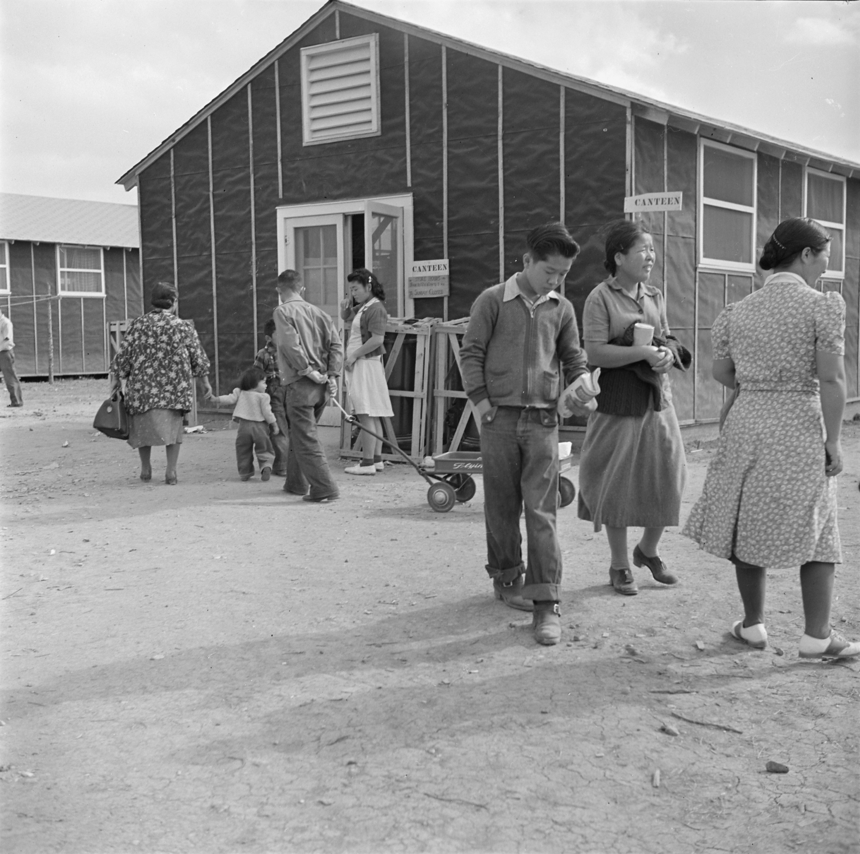 Japanese-American internees outside the canteen of Block 8 of Jerome War Relocation Center, Arkansas, United States, 17 Nov 1942