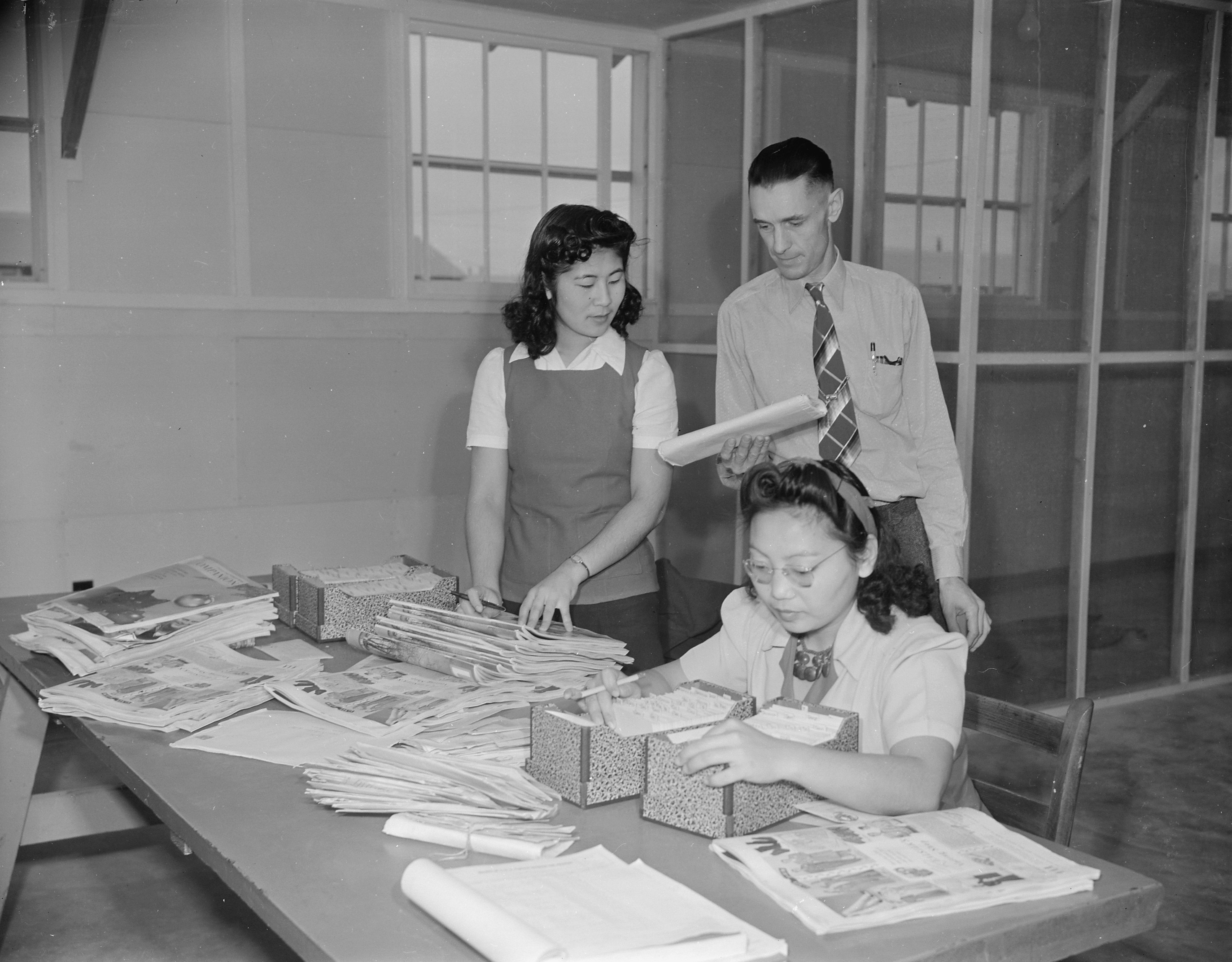 Postmaster Fred R. Paris with mail clerks, Jerome War Relocation Center, Arkansas, United States, 20 Nov 1942