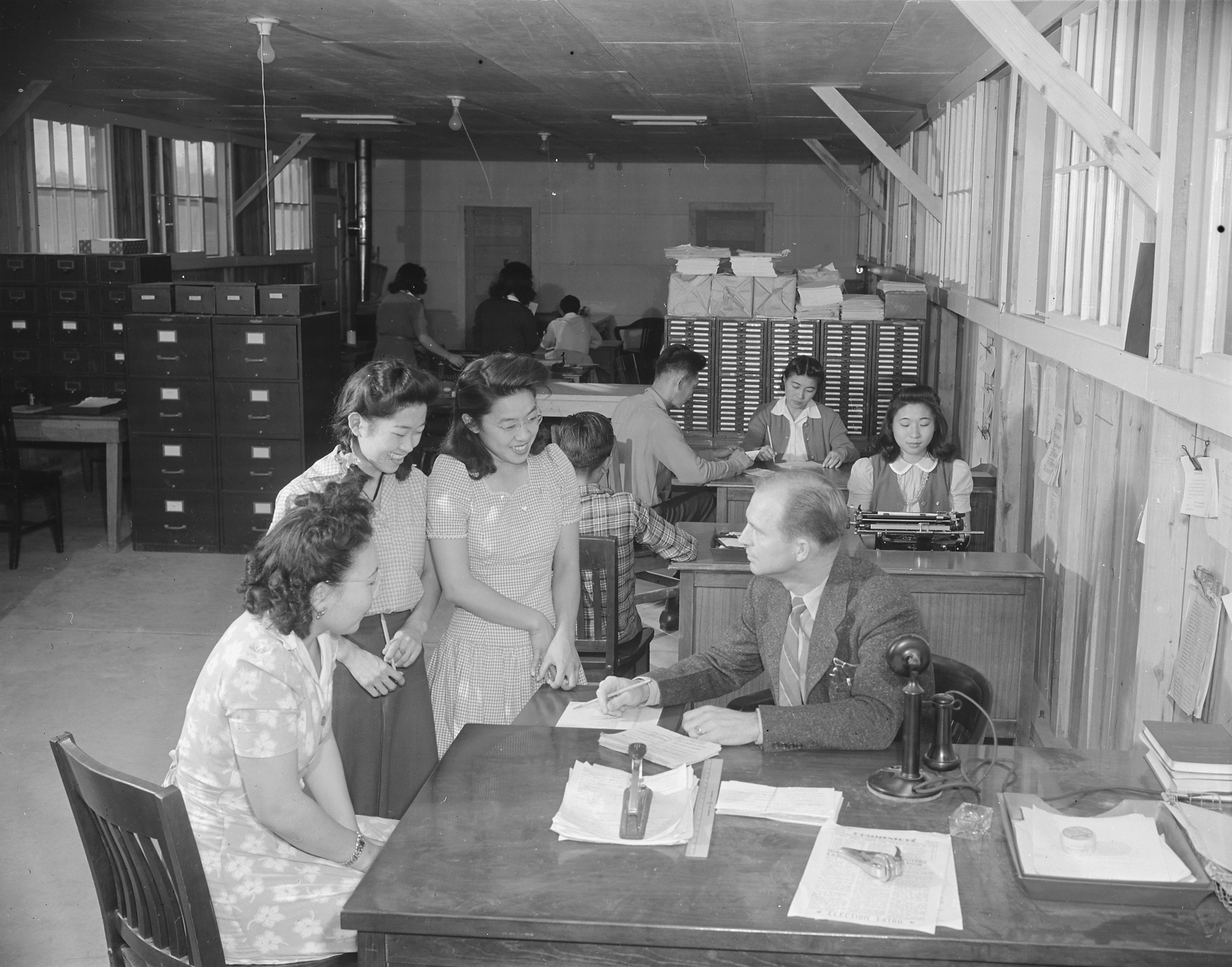 Placement Officer W. C. Love with his office staff, Jerome War Relocation Center, Arkansas, United States, 18 Nov 1942