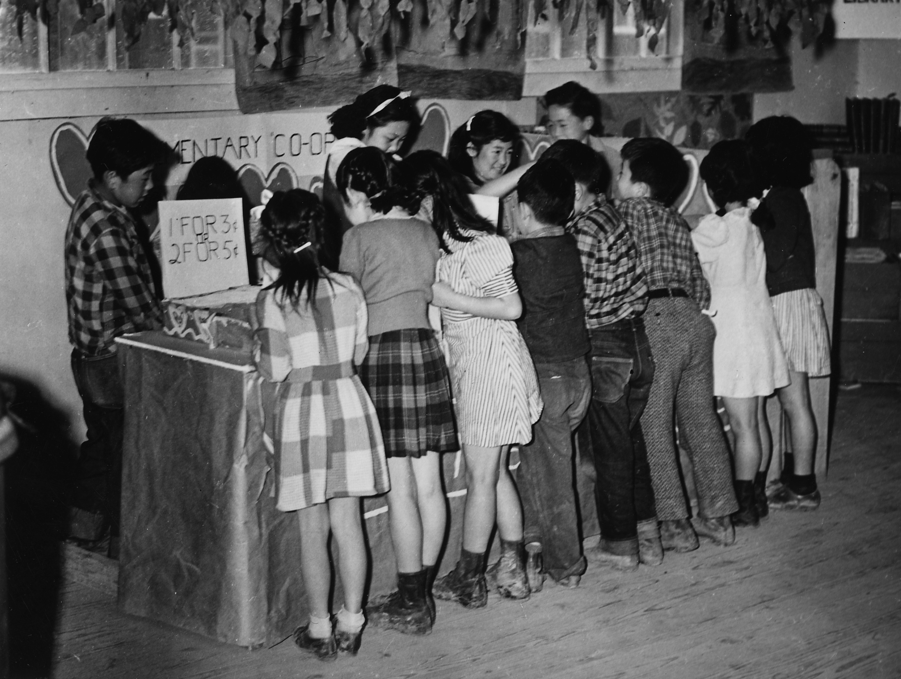 Fourth grade Japanese-American children at a cooperative store stand selling valentines, Jerome War Relocation Center, Arkansas, United States, Feb 1944, photo 1 of 3