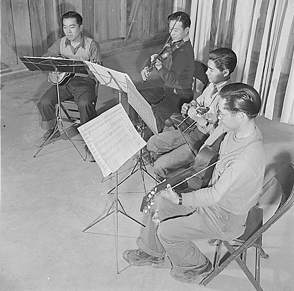 A string quartet practing, Jerome Relocation Center for Japanese-Americans, Jerome, Arkansas, United States, 12 Mar 1943; left to right: Yutaka Motasuda, Seichi One, John Yamashita, and Joe Iwasaki