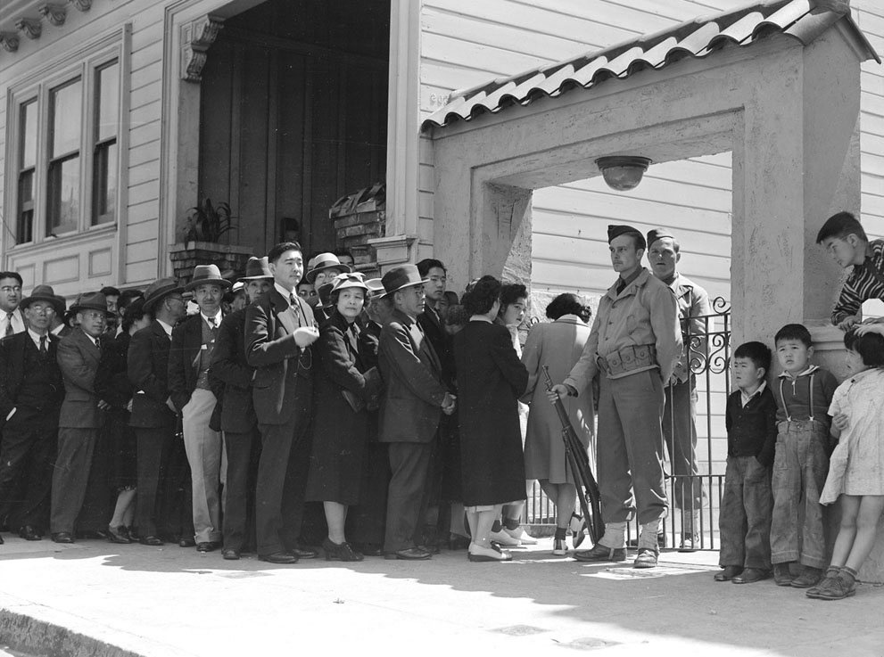 Japanese-Americans outside a Civil Control Station at the Japanese American Citizens League Auditorium, San Francisco, California, United States, 25 Apr 1942