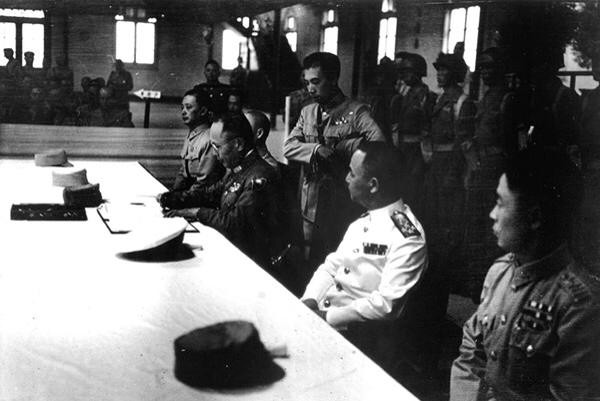 Chinese General He Yingqin signing the Japanese surrender document at the Chinese Military Academy in Nanjing, China, 9 Sep 1945, photo 2 of 2