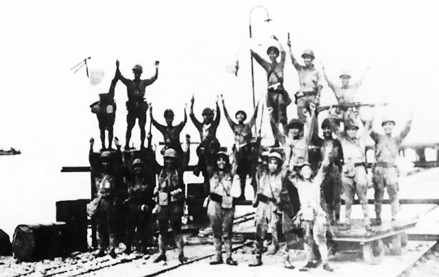 Men of the Japanese 2nd Division celebrating successful landing, Merak, Java, 1 Mar 1942