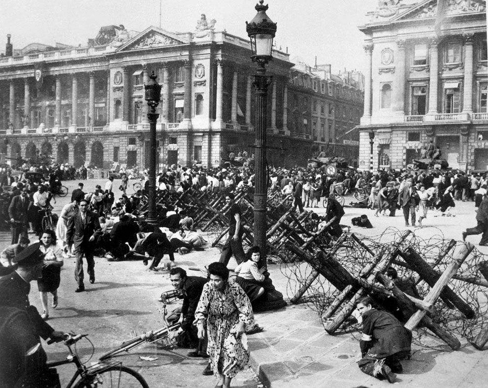 French civilians seeking cover as an unexpected German sniper opened fire at a group of American soldiers, Paris, France, 26 Aug 1944
