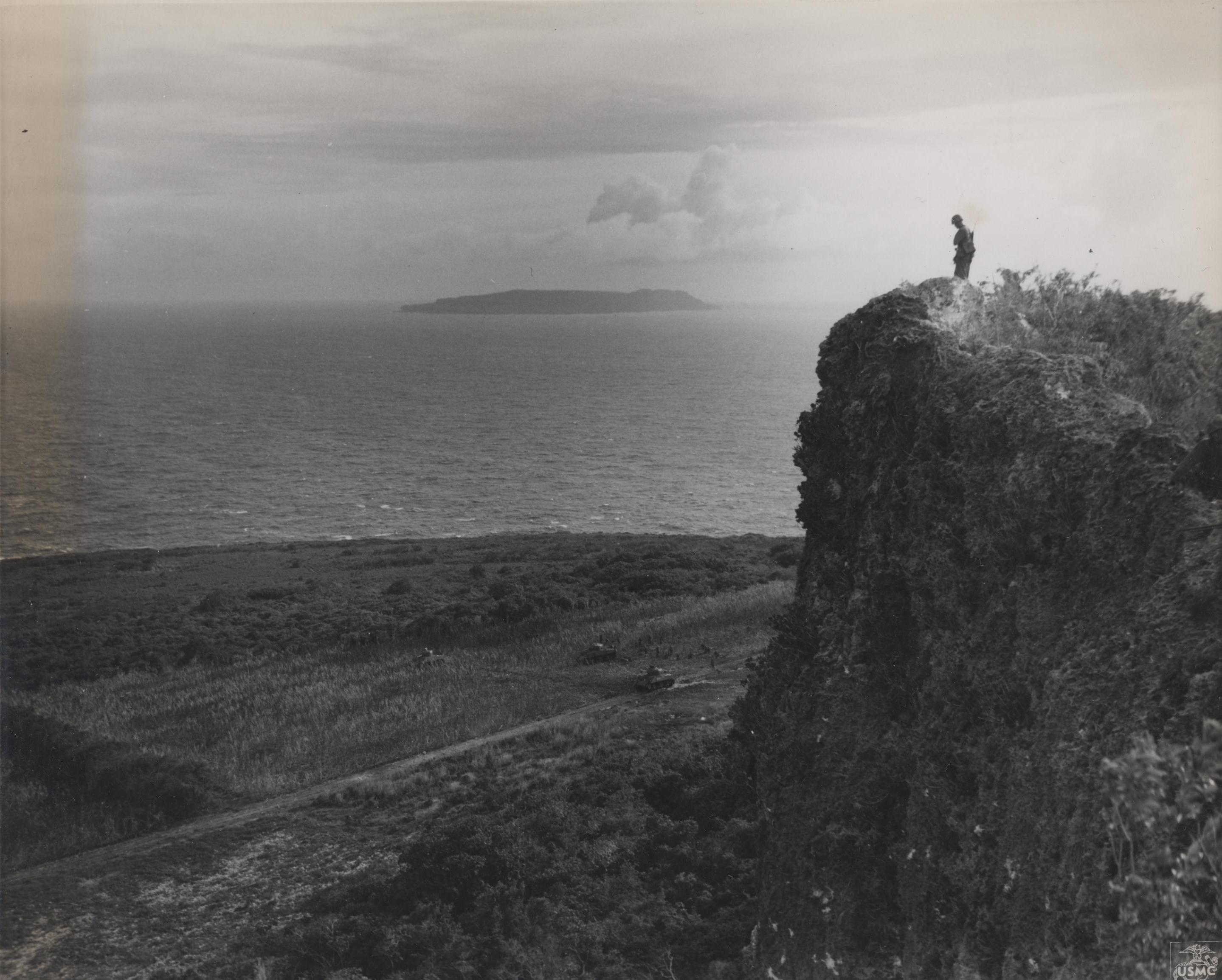 A US Marine standing at the edge of a cliff on Tinian, Mariana Islands, 1944