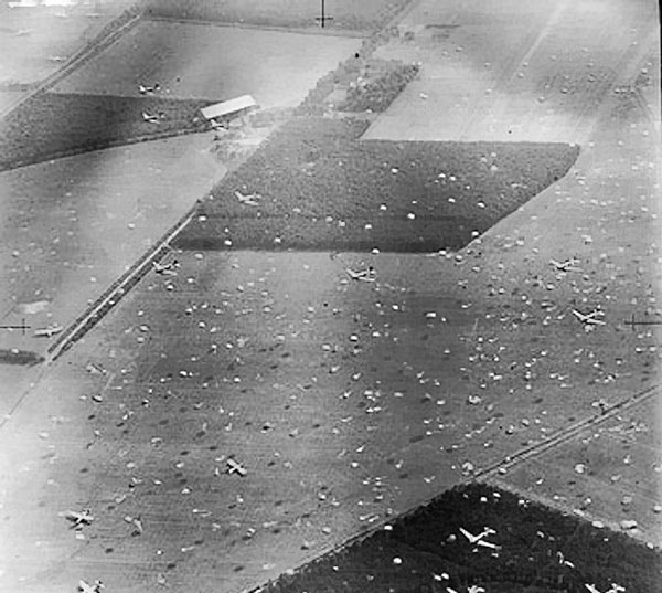 Reconnaissance photograph showing Dakota aircraft dropping paratroopers of 1st Airborne Brigade on to Dropping Zone 'X', at Renkum, west of Arnhem, Operation Market I, 17 Sep 1944