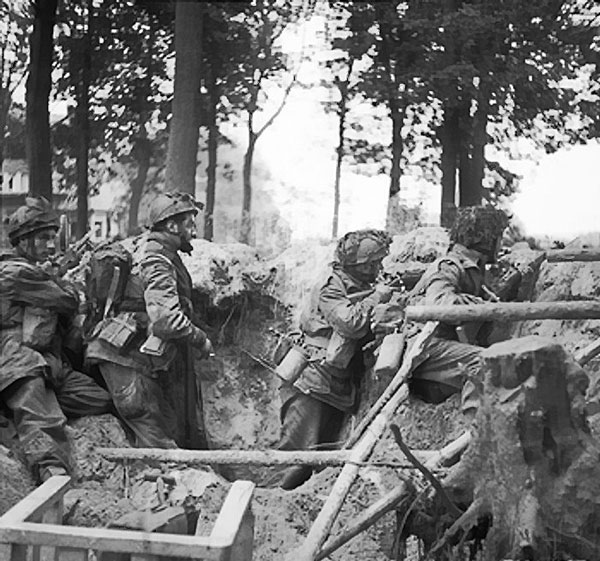 Four men of the 1st Paratroop Battalion, British 1st Airborne Division, took cover in a shell hole outside Arnhem, Netherlands, 17-25 Sep 1944