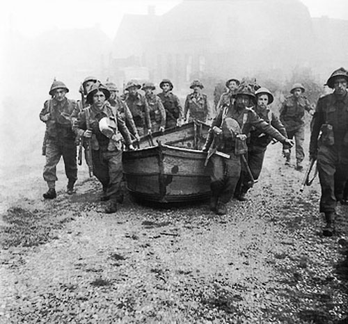British infantry carrying assault boats in preparation for crossing the Meuse-Escaut canal at Lille-St Hubert, Belgium, 19 Sep 1944