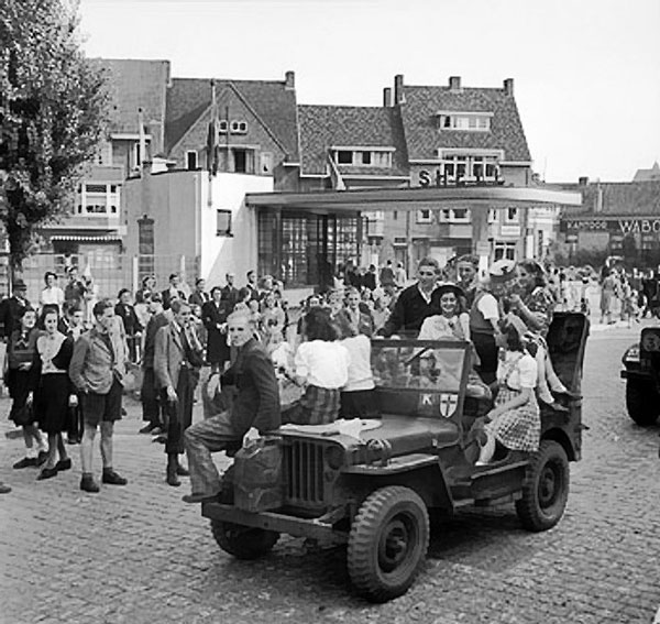 Dutch civilians riding on a British jeep during the advance towards Nijmegen, the Netherlands, 20 Sep 1944
