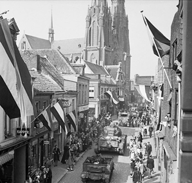 The people of Eindhoven, the Netherlands lined the streets of the town to watch armored vehicles of British XXX Corps passing through, 19 Sep 1944