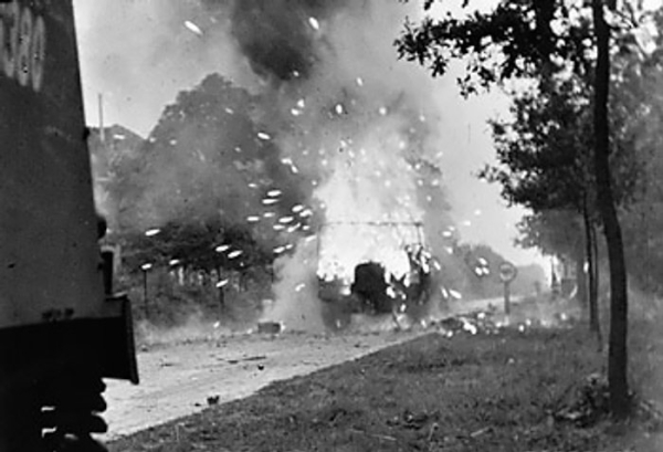A Loyd carrier of the anti-tank platoon of 3rd Battalion, Irish Guards exploded during British XXX Corps' advance toward Eindhoven, Noord-Brabant, the Netherlands, 17 Sep 1944