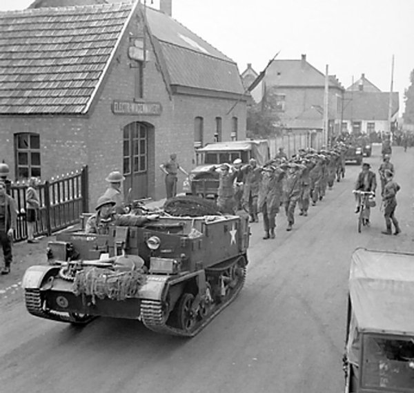 Men of 158 Brigade, UK 53rd (Welsh) Division escorting German prisoners, the Netherlands, 19 Sep 1944; note Universal Carrier leading the column