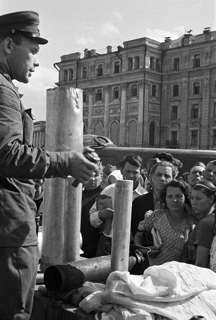 Soviet soldier teaching civilians how to disarm a un-exploded German incendiary bomb, Sverdlov Square, Moscow, Russia, 1 Sep 1941