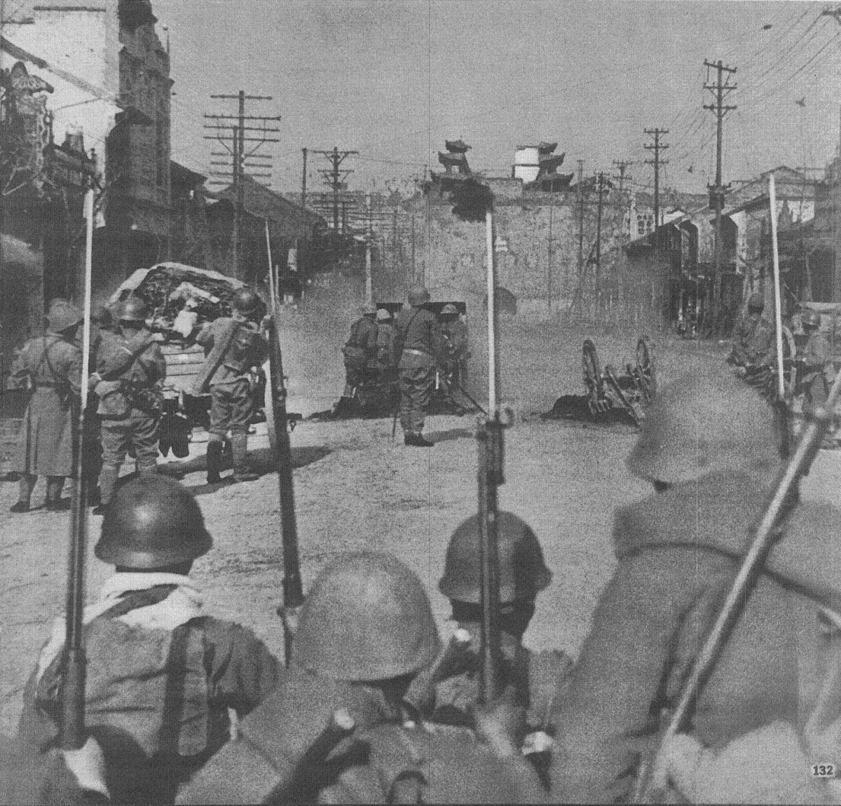 Japanese troops attacking the Zhonghua Gate of the Nanjing city wall with a field gun, China, 12 Dec 1937