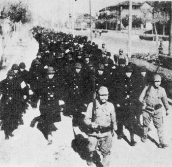 Japanese troops escorting 450 captured Nanjing policemen, China, 17 Dec 1937; most of them would be executed en masse later that day outside the West Gate of the city wall