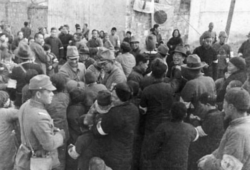 Japanese officers with Chinese civilians, Nanjing, China, 17 Dec 1937, photo 2 of 3