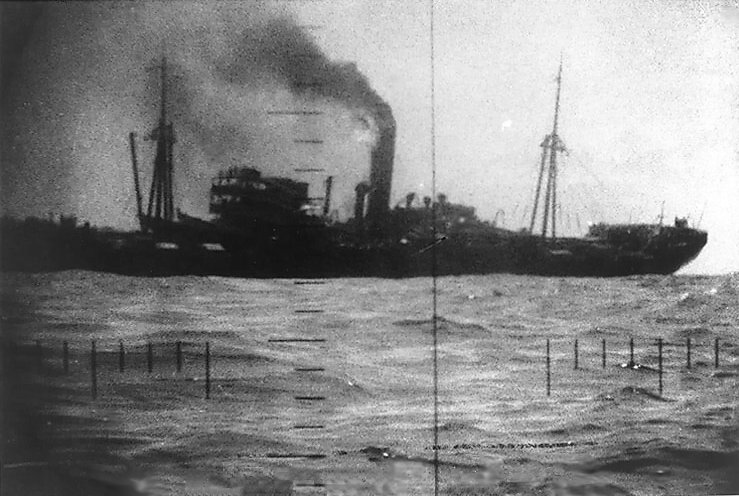 Japanese transport Buyo Maru beginning to sink after being struck by USS Wahoo's torpedo north of New Guinea, 26 Jan 1943; seen from USS Wahoo's periscope
