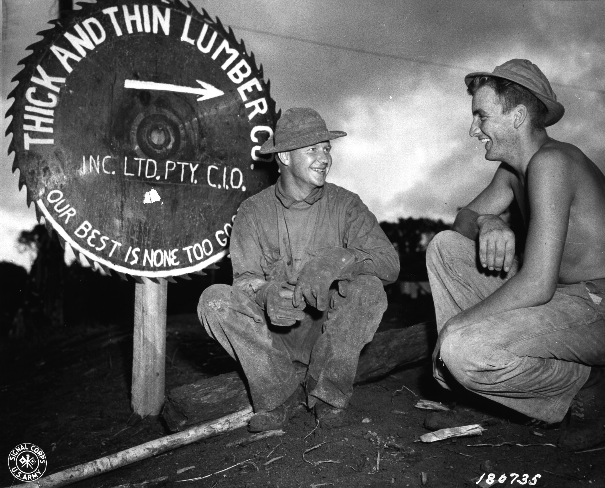 US Army Private Arthur Ristinen and Private First Class John Weinzinger of 186th Regiment, 41st Infantry Division relaxing in front of Warisota Plantation, New Guinea, 5 May 1943