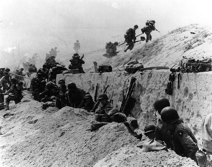 Americans of the 8th Infantry Regiment, 4th Infantry Division moved out over the seawall on Utah Beach, Normandy, 6 Jun 1944