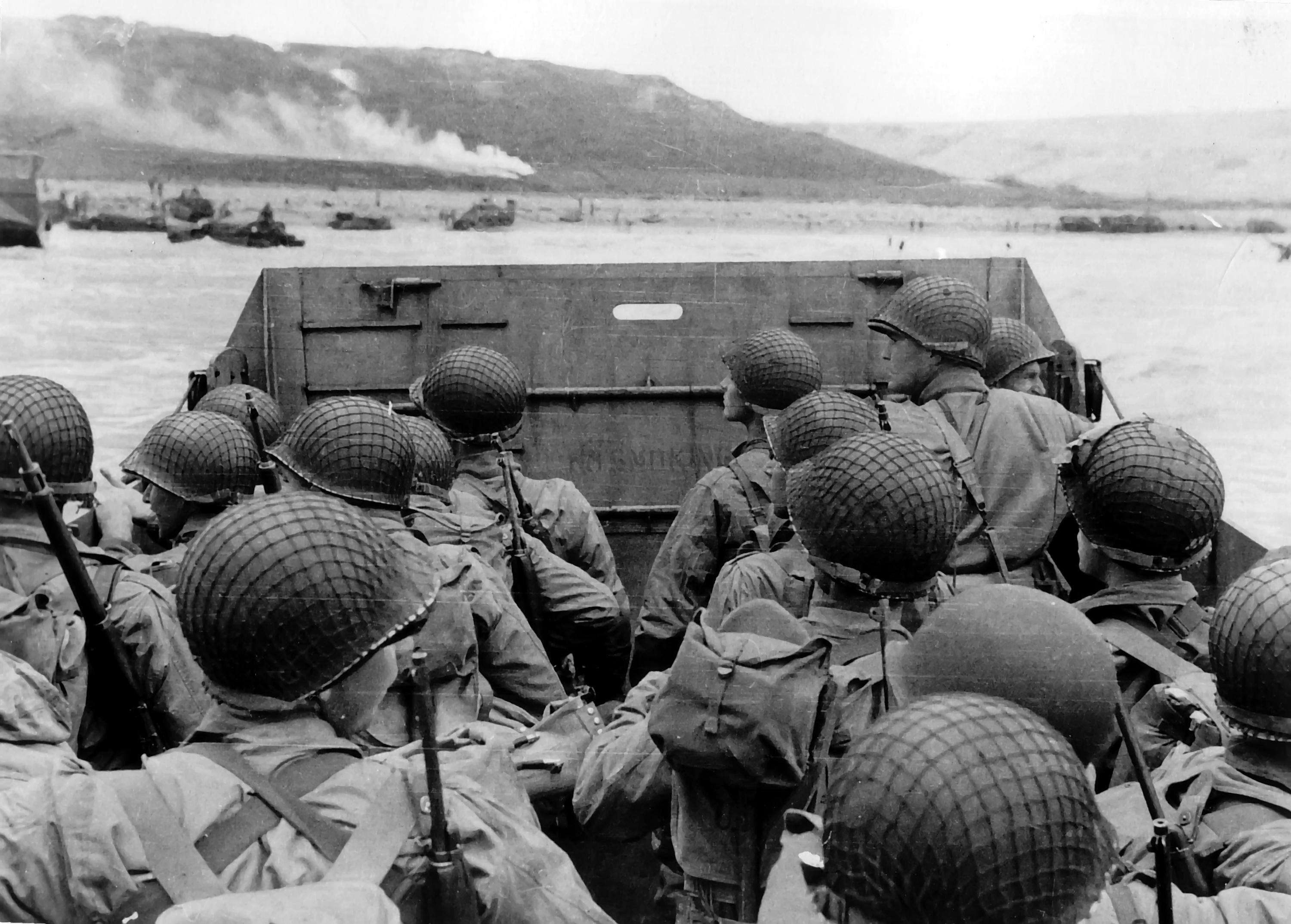 American troops watched activity ashore on Omaha Beach as their LCVP landing craft approached the shore, Normandy, 6 Jun 1944, photo 1 of 2