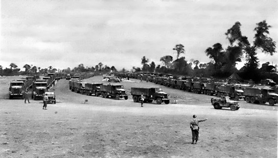 US Army trucks of the 'Red Ball Express' moving through a regulating point, possibly France, circa mid-1944
