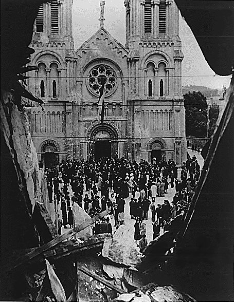French civilians gathering in front of damaged Église Notre-Dame-du-Vœu, Cherbourg, France, 22 Aug 1944