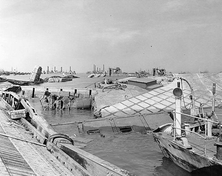 Wrecked pontoon causeway of one of the 'Mulberry' artificial harbors, following the storm of 19-22 Jun 1944, off Normandy, France, 23 Jun 1944