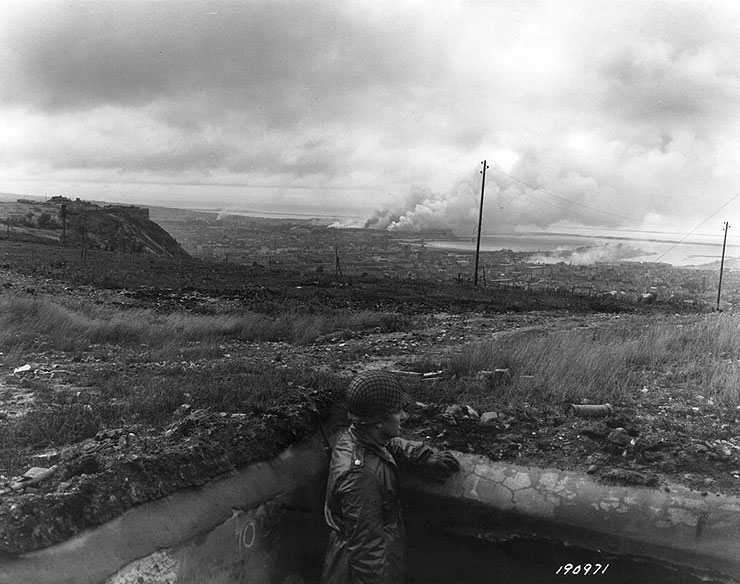 A US Army major looked over Cherbourg from one of the concrete pillboxes above the city, 26 Jun 1944