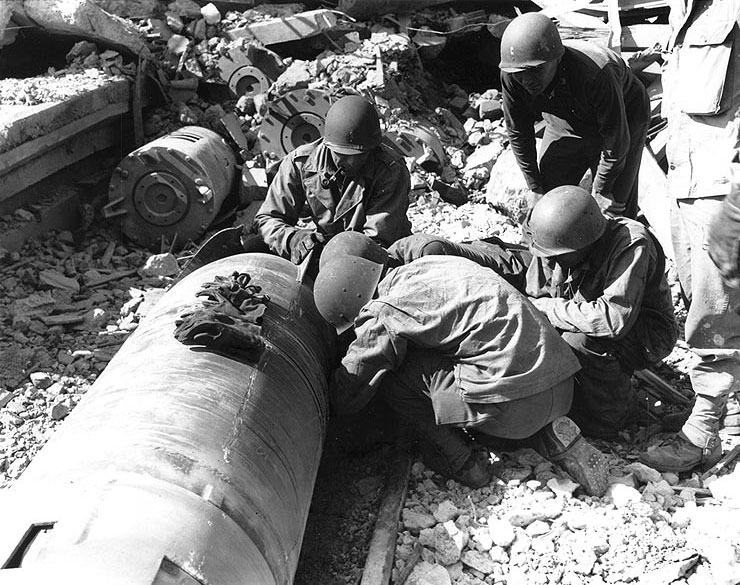 2nd Lieutenant P.H. Shupp's US Army engineers disarming a mine found under docks at Cherbourg, 17 Jul 1944