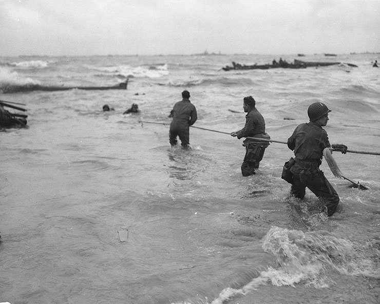 American troops used a lifeline to rescue several men from a sunk landing craft, Normandy, 6 Jun 1944