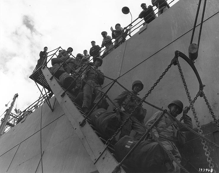 American troops leaving the first troop transport to enter Cherbourg harbor, 25 Jul 1944