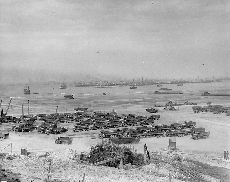 Allied cargo transfer point on Omaha Beach, 19 Jul 1944; note British battleship Centurion in the center of background
