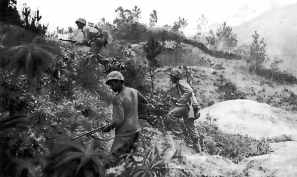 US Marines advancing up a hill, Okinawa, Japan, circa Apr-Jun 1945