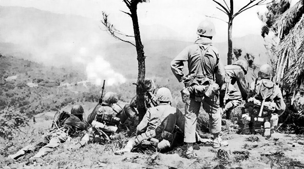 Men of the US 6th Marine Division observing shelling of a Japanese position near Yae Take Airfield, Okinawa, Japan, 14 Apr 1945