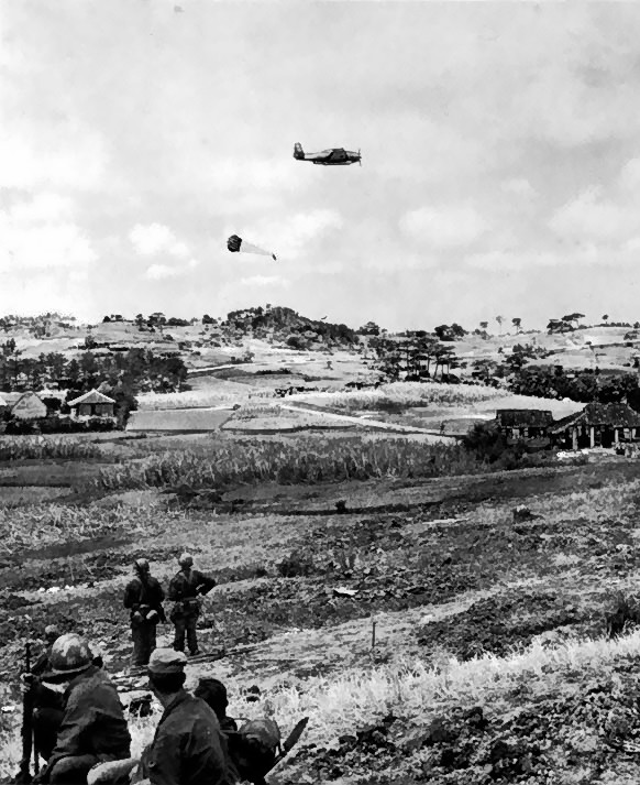 US Navy TBM-R or TBM-S Avenger aircraft dropping supplies in Korea, circa 1950-1953