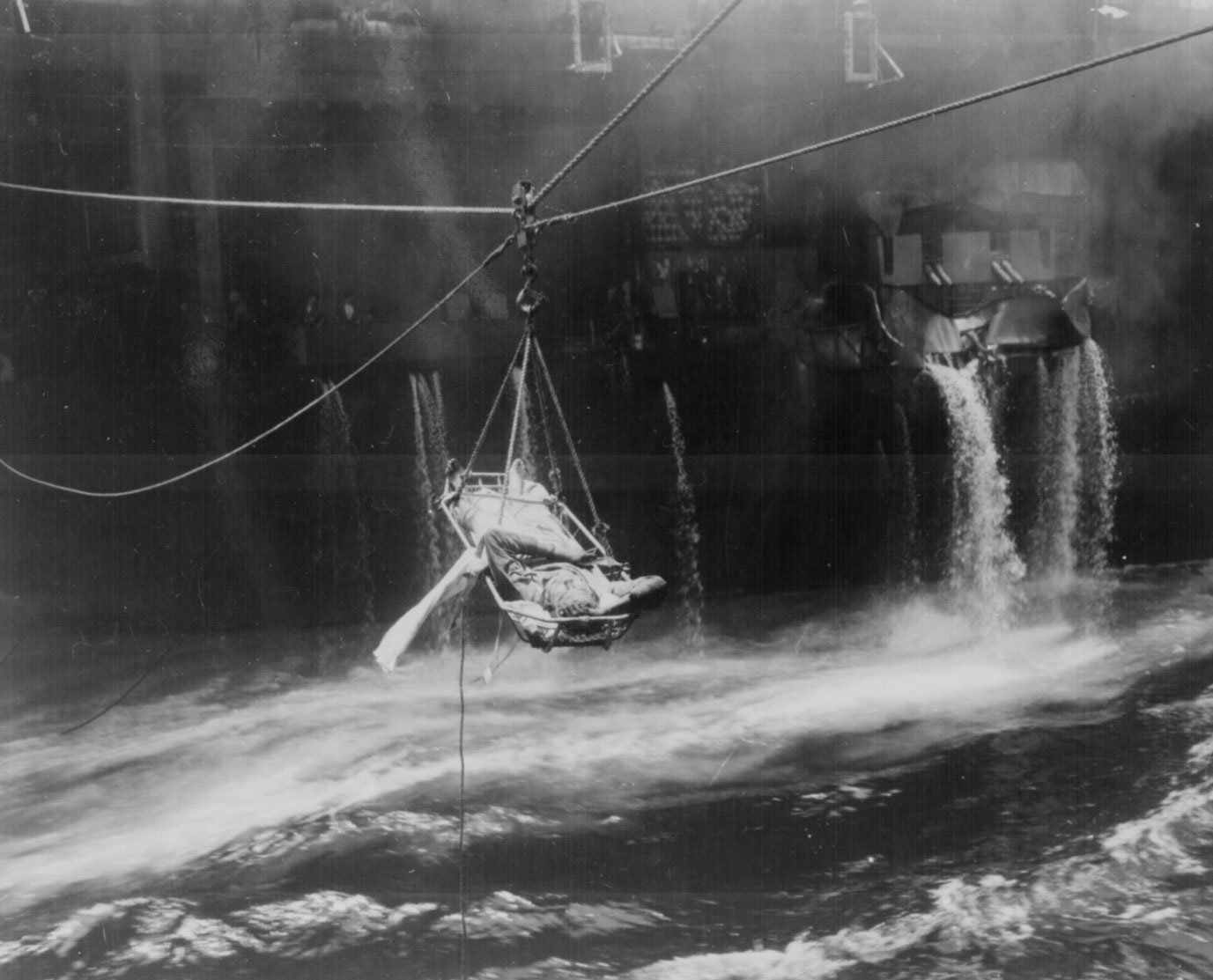 Transfer of wounded from USS Bunker Hill to USS Wilkes Barre, who were injured during fire following suicide dive bombing attack off Okinawa, 11 May 1945