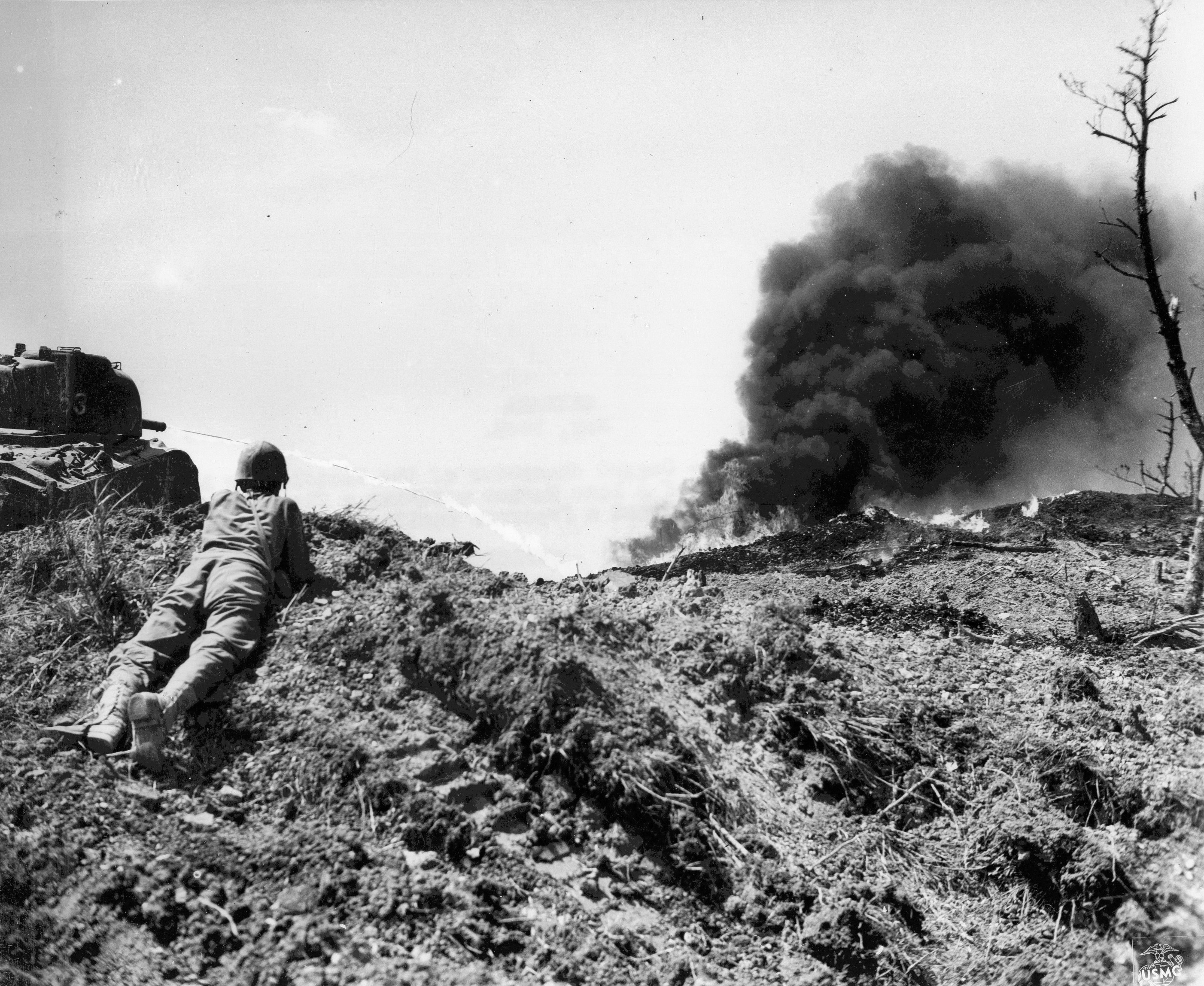 US Marine observing a Japanese position as a flame thrower attacked it, Okinawa, Japan, May 1945