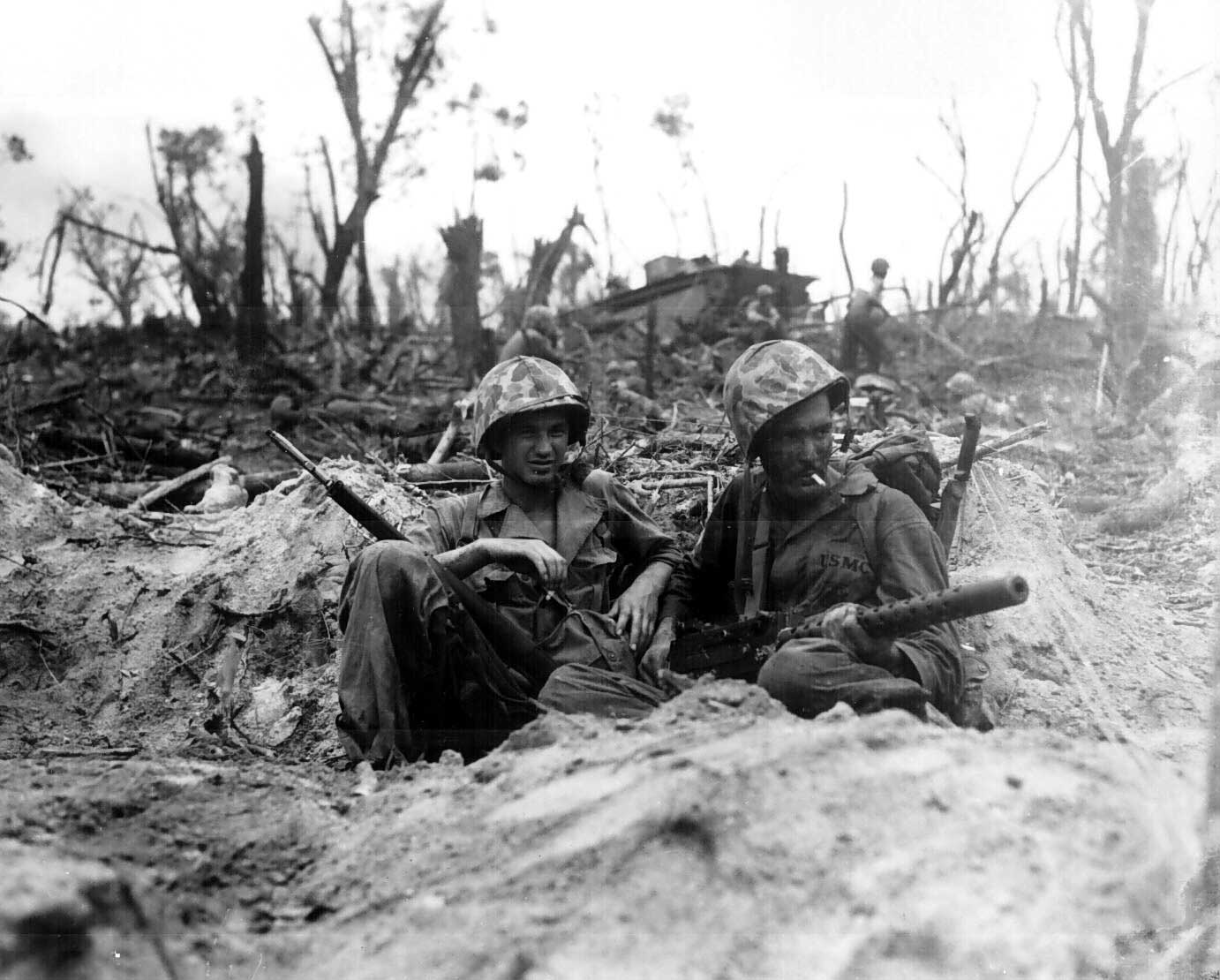 Two American Marines, Douglas Lightheart and Gerald Thursby, resting during Battle of Peleliu in the Palau Islands, 15 Sep 1944