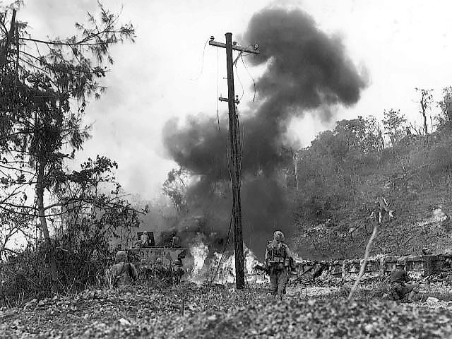 US Marines moving through an area that saw recent action, Peleliu, Palau Islands, Sep 1944
