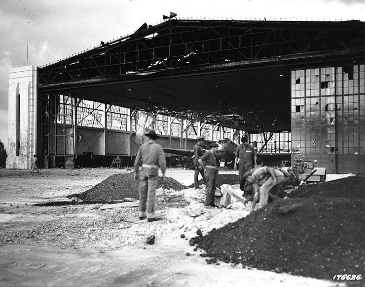 Bomb damage to Hangars 15-17 and 11-13 at Hickam Field, Oahu, at 1700 on 7 Dec 1941; note B-18 bomber in hanger