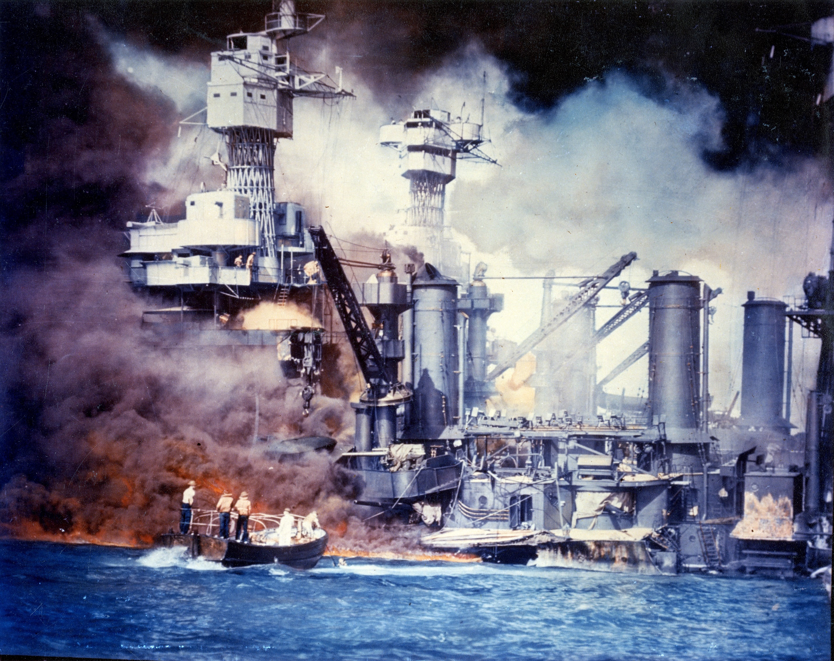 Sailors in a motor launch rescued a survivor from the water alongside the sunken West Virginia during or shortly after the Japanese air raid on Pearl Harbor, 7 Dec 1941, photo 2 of 2; note false color