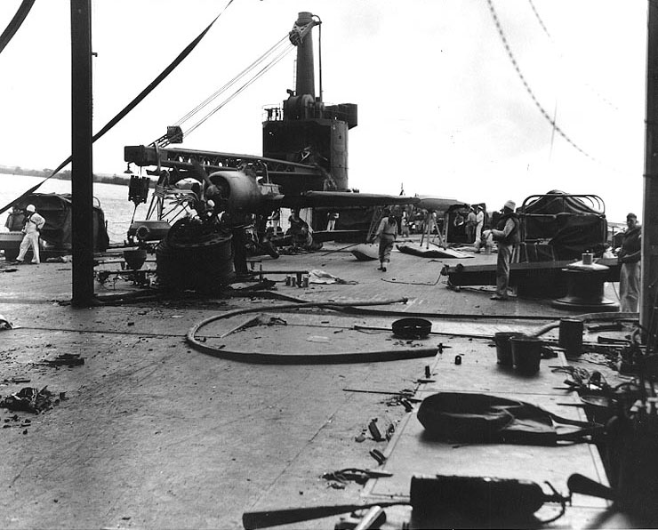 Scene on main deck of seaplane tender Curtiss after Pearl Harbor attack, 7 Dec 1941; note burned out OS2U-2 floatplane on deck