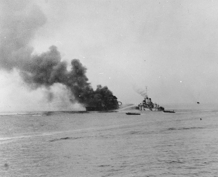 APD Ward burning in Ormoc Bay, Leyte, Philippine Islands, after being struck by special attack aircraft, 7 Dec 1944; the firefighting ship was destroyer O'Brien, and photo was taken from APD Crosby